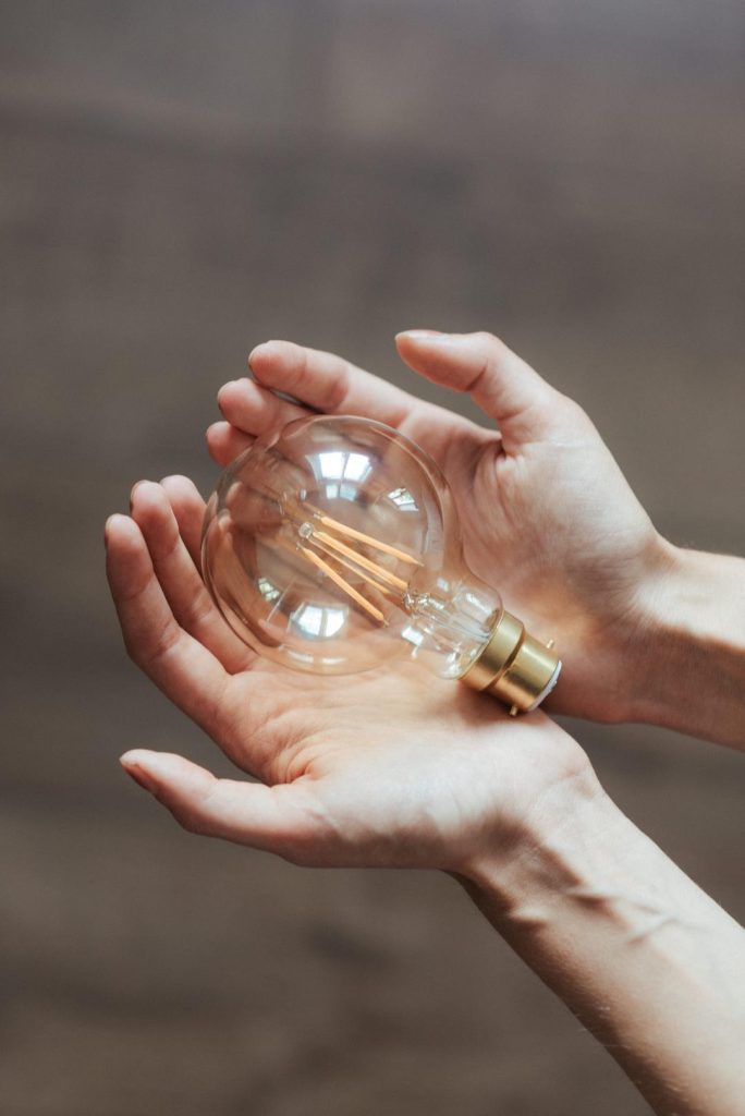 Person holding a light bulb